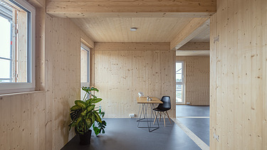 News ZÜBLIN Timber. German Timber Construction Award 2025. Photo of an interior with many wooden surfaces. Collegium Academicum Heidelberg.