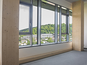 Foto eines innenliegenden Fensterausschnittes. Zu sehen sind BSH-Stützen.