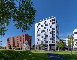 Foto eines mehrgeschossigen Gebäudes mit weißer Fassade.