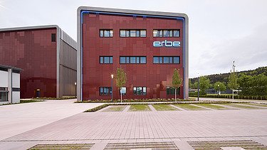 Photo of a wooden building with a red façade.