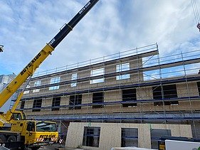 Foto der Montage der LENO-Brettsperrholzelemente. Man sieht große Holzelemente.