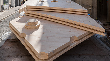 Photo of a stack of wooden panels with LENO cross-laminated timber elements