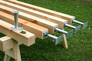 Photo of the legs of the stanchions mounted on squared timber and resting on trestles.