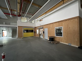 Photo of the interior fit-out of a commercial building. You can see LENO cross-laminated timber walls and ceilings.