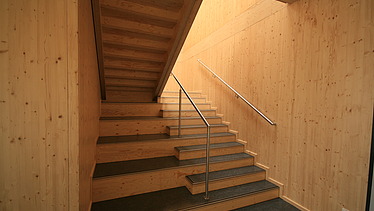 Foto eines Treppenaufganges aus Holz.