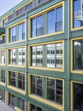 Coloured timber façade as ornamental façade with relief formwork.
