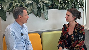Two people sitting on the couch in an interview