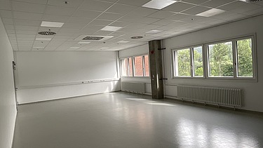 Photo of a large, bright room that is empty.