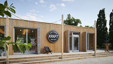 Photo of a wooden building with flat roof and terrace.
