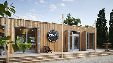 Photo of a wooden building with flat roof and terrace.