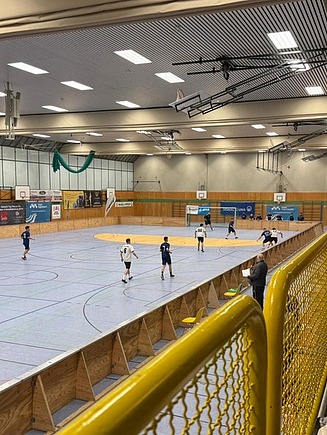 Photo with a view from the stands onto a soccer pitch in the sports hall of Aichach Grammar School.