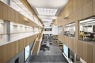 Photo of a large interior with many wooden surfaces.