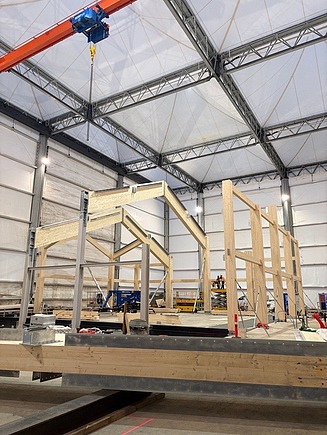 Construction of the main roof trusses of the church hall structure.