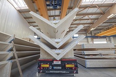Photo of a truck trailer loaded with three LENO V-shaped cross-laminated timber elements.