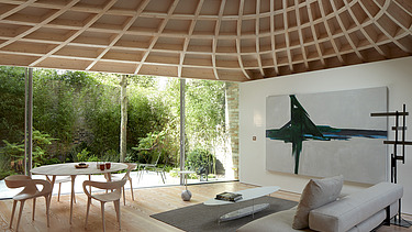 Photo of a living room with an eye-catching, curved wooden ceiling