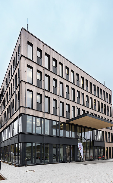 Foto eines mehrgeschossigen Holzbaugebäudes. Büroneubau T3 von ZÜBLIN Timber in Aichach.