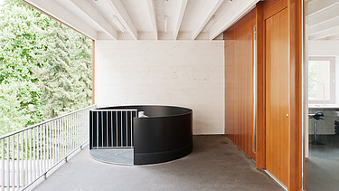 Photo of a balcony with visible, white ribbed wooden ceiling. Wooden extension.