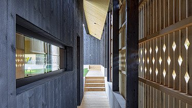 Photo of a modern wooden house with wooden facade. Detail picture facade.