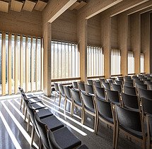 Photo of the interior seating of the Tau Kirke in Norway. You can see the wooden skeleton structure of the ceiling and wooden elements on the wall.