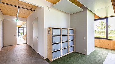 Photo of an office space. You can see a locker and wooden ceiling.