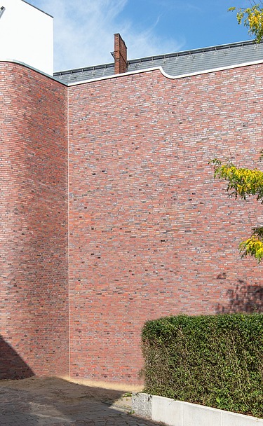 Foto eines Holzhauses mit Klinkerfassade.